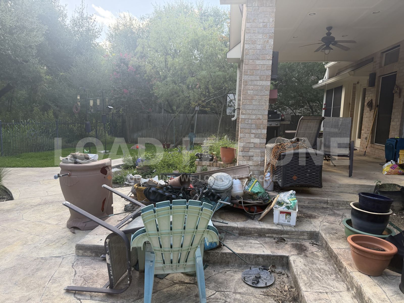Patio covered in junk before removal